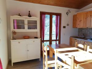 a kitchen and dining room with a table and chairs at Casetta delle olive in Tremosine Sul Garda