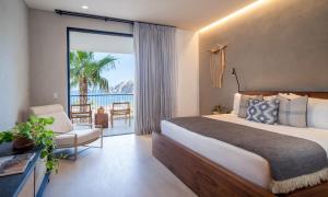 a bedroom with a bed and a view of the ocean at 1 Homes Preview Cabo in Cabo San Lucas