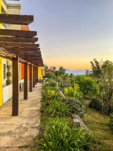 a walkway next to a building with a sunset in the background at Casa 1800 Ataco Hotel Boutique in Concepción de Ataco