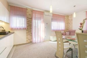 a kitchen and living room with a table and chairs at Apartment SARA - free parking for 2 cars in Zagreb +13 photos