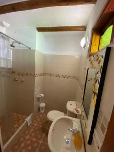 a bathroom with a sink and a toilet and a shower at Hotel - Hospedería Villa Palva in Villa de Leyva