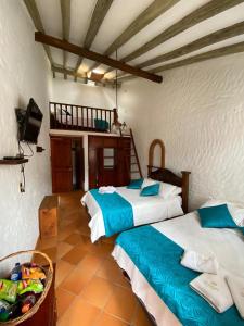 A bed or beds in a room at Hotel - Hospedería Villa Palva