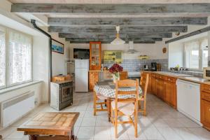 a kitchen with a table and chairs in a room at Maison charmante avec vue sur la mer à Paimpol in Paimpol +12 photos