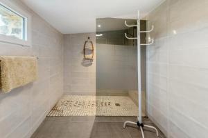a shower with a glass door in a bathroom at Maison charmante avec vue sur la mer à Paimpol in Paimpol