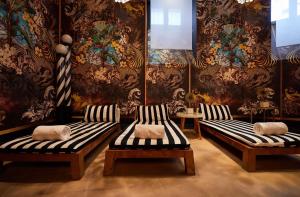 a room with two benches and a wall with wallpaper at Radisson Blu Hotel, Madrid Prado in Madrid