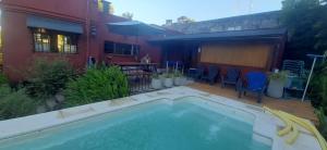 a swimming pool in the backyard of a house at Cabaña Isla Paihuen in Tigre