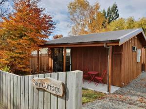 a small shed with a sign in front of it at Star Cottages in Lake Tekapo