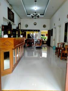 a living room with a dining room and a living room with a table at Prayogo Lama Prawirotaman in Yogyakarta