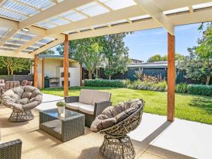 a patio with two chairs and a table at Within Oceans Reach in Cape Woolamai