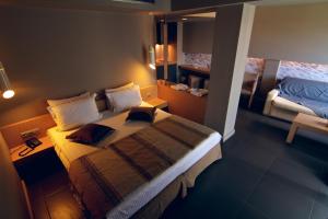 Postel nebo postele na pokoji v ubytování Elysion Hotel