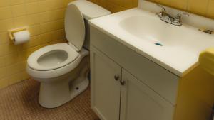 een badkamer met een wit toilet en een wastafel bij Red Horse Motel Dayton Moraine in Dayton