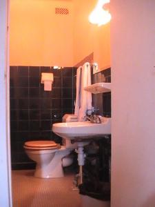 a bathroom with a toilet and a sink at Hôtel de Lorraine in Paris