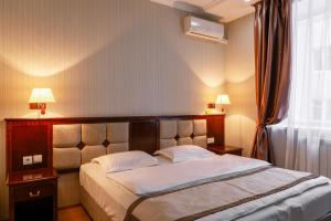 Un pat sau paturi într-o cameră la Ethno Hotel Orto Doydu