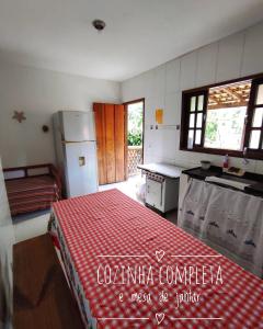 a kitchen with a red checkered table cloth on a table at Casa espaçosa famíliar in Paraty +29 photos