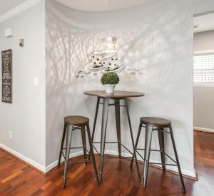 a table and two stools in a room with a wall at Amazing Midtown Atlanta Location by Piedmont Park Beltline Ponce City Market in Atlanta