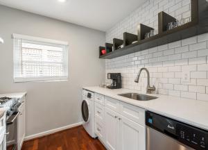 a white kitchen with a sink and a dishwasher at Amazing Midtown Atlanta Location by Piedmont Park Beltline Ponce City Market in Atlanta