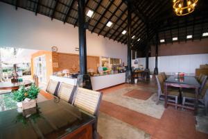 a large living room with a table and chairs at Koh Mak Resort in Ko Mak