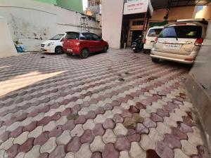 a parking lot with cars parked in a building at Kaveri Hotel Bed & Breakfast in Mysore