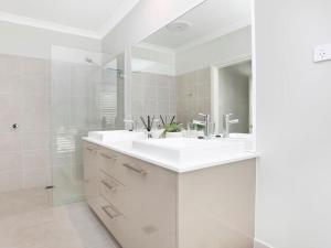 a white bathroom with a sink and a shower at The Bunkhouse in Exeter