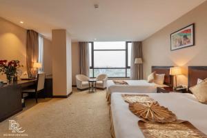 Ένα ή περισσότερα κρεβάτια σε δωμάτιο στο Red River View Hotel