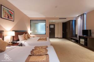 Ένα ή περισσότερα κρεβάτια σε δωμάτιο στο Red River View Hotel