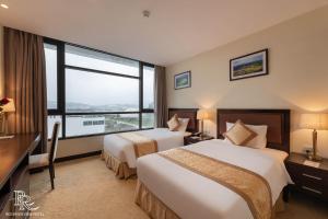 Ένα ή περισσότερα κρεβάτια σε δωμάτιο στο Red River View Hotel