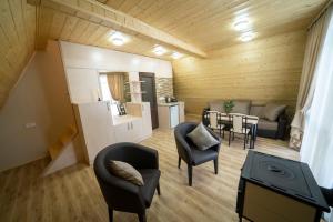a living room with a kitchen and a dining room at Woodland cottages in Tsaghkadzor