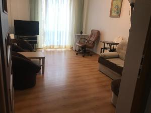 a living room with a couch and a television at Mieszkanie Dla Turystów in Sandomierz