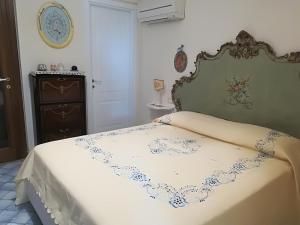 a bedroom with a bed with a white blanket at Villa Stella del mare in Positano