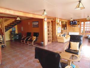 a living room with a couch and a table at Nikos II Adventure in Puerto Natales