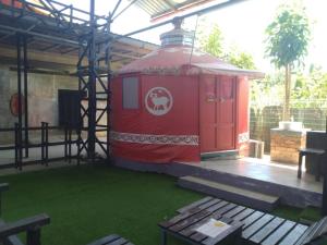 a red dog house sitting on a patio at Rick Resort Teluk Intan in Teluk Intan