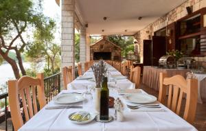 a long table with a bottle of wine on it at Villa Jagodna in Hvar