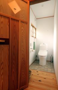 a bathroom with a toilet and a wooden door at HÏSOM - Vacation STAY 19778v in Oda