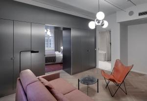 a living room with a couch and a bedroom at Boutique Hotel Ottilia in Copenhagen +61 photos