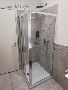 a shower with a glass door in a bathroom at Casa del Caffè in Trieste