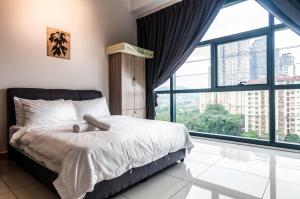 a bedroom with a bed and a large window at 3 Towers Gleaneagles Jalan Ampang By IdealHub in Kuala Lumpur