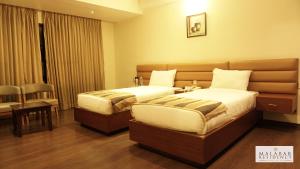 Malabar Residency客房内的一张或多张床位