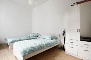 a bedroom with two beds and a dresser at Apartment mit 2 Schlafzimmern in Bergisch Gladbach