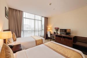 Ένα ή περισσότερα κρεβάτια σε δωμάτιο στο Red River View Hotel