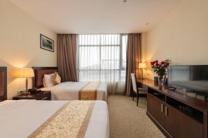 Ένα ή περισσότερα κρεβάτια σε δωμάτιο στο Red River View Hotel