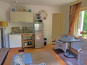 a kitchen with a refrigerator and a table and chairs at Villa Prinsenhof # Zestien in Bergen