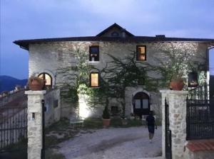 a stone house with a gate in front of it at Dimora di Charme Villa Sant'Erasmo in Fumone