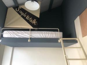 Uma cama ou camas num quarto em Simple Walk Guest House 小公寓