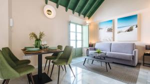 a living room with a couch and a table at Magno Apartments Rocío in Seville