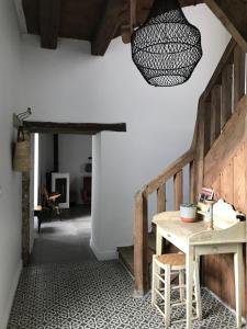 a dining room with a table and a chandelier at Le Mottay Guesthouse in Saint-Père-en-Retz