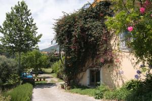 a house with flowers on the side of it at B&B La casa dei gelsi in Loano