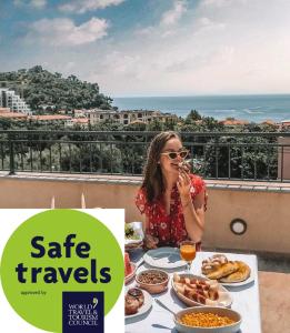 a woman sitting at a table with food at Guest House Medin in Petrovac na Moru