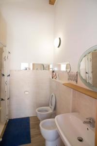 a bathroom with a toilet and a sink and a mirror at B&B La casa dei gelsi in Loano