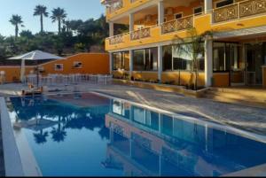 a large swimming pool in front of a building at Le Quattro Rose in Diamante