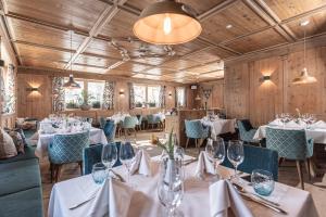 a dining room with white tables and chairs at Galtenberg Bed & Breakfast in Alpbach